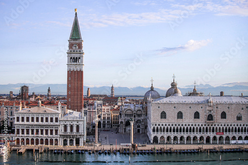 Aerial view of St. Mark's Campanile and the Doge's Palace overlooking the historic waterfront and lagoon in Venice, Veneto, Italy.