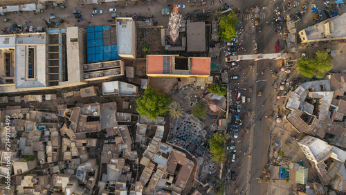 Aerial view of the historic city of Kano, featuring dense urban architecture, flat-roofed buildings, a prominent communication tower, and busy streets, Kano, Kano, Nigeria.