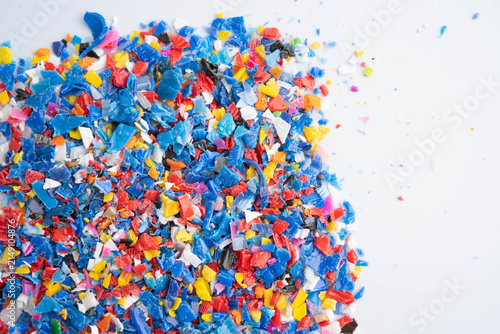 Fotografie Plastic colorful pieces recycling shredded for industrial use.