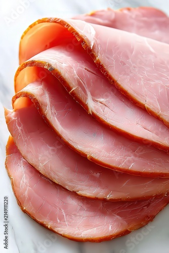 Sliced deli meat arranged neatly on a marble surface, ideal for use in food blogs, menus, or culinary promotions, showcasing freshness and quality in deli offerings,