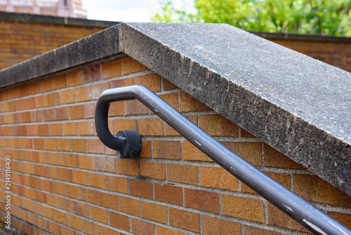 Durable wall mounted metal handrail with a sleek black or galvanized finish, designed for safe and practical outdoor stair use.