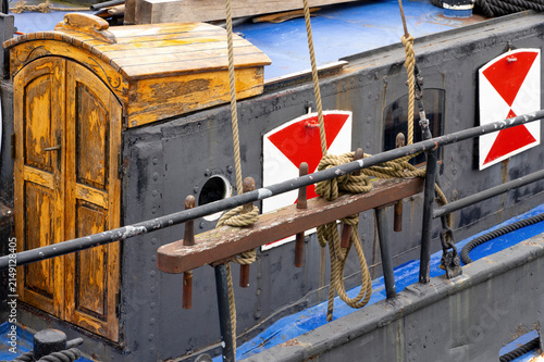 фотографія Historic Inland Waterway Barge with Wooden Cabin and Traditional Mooring Equipme