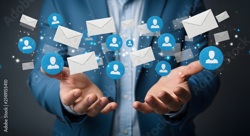 Professional Businessman Holding Digital Floating Email Icons and Networking Contacts Representing Global Corporate Communication Strategy