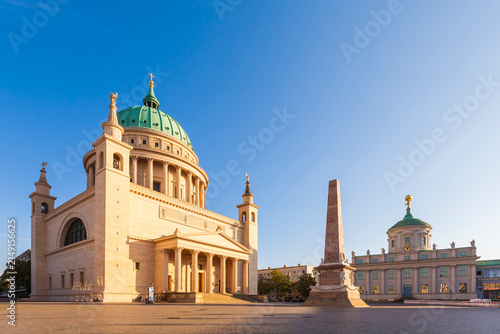 Germany, Potsdam, view to St. Nicholas church, obelisk and old city hall at old market in the evening