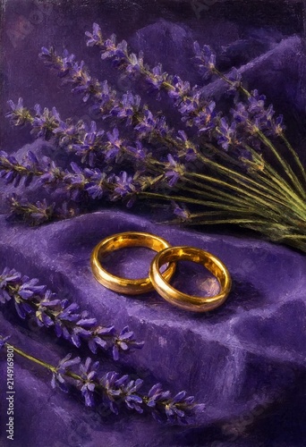 Two golden wedding rings placed on soft purple fabric with fresh purple lavender flowers