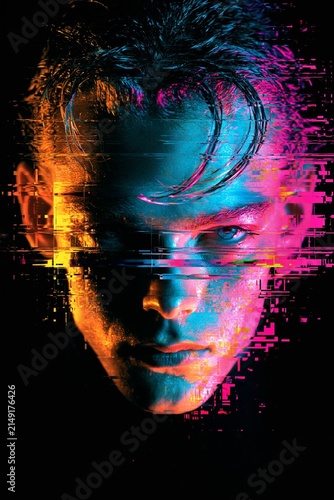 Close-up of a young man's face digitally glitched with vibrant neon blue orange and pink lighting on a black background