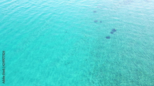 Top down aerial view of crystal clear turquoise sea water texture background