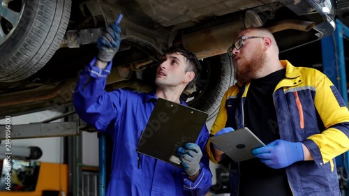 Professional mechanic technician engineer expert person maintenance garage repair shop focus concentration automotive vehicle teamwork