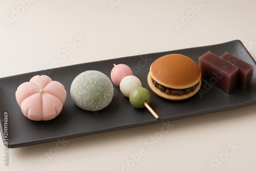 Traditional Japanese wagashi assortment on black ceramic plate with copy space