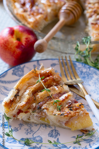 Piece of pie with nectarines and camembert.