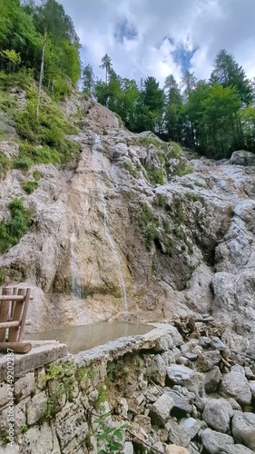 Summer Palenk waterfall cascading down steep rocks in Logar valley Slovenia