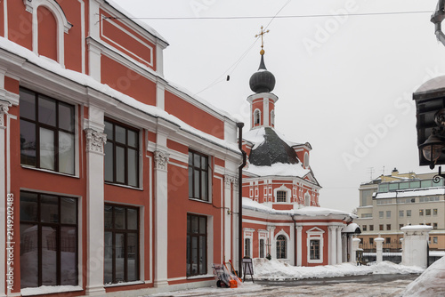 Moscow, Russia, December 20 2025. St. Catherine's Church on Vspolye, a traditional Russian Orthodox church featuring classic red and white baroque architecture under a winter snow cover.