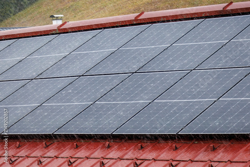 Rooftop solar panels during a torrential downpour.