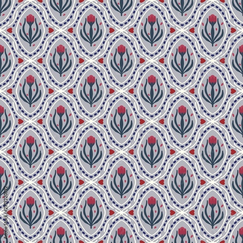 Seamless floral damask vector pattern with hand drawn stylized red tulips and ogee ornaments in navy blue, white, and red on a grey background.