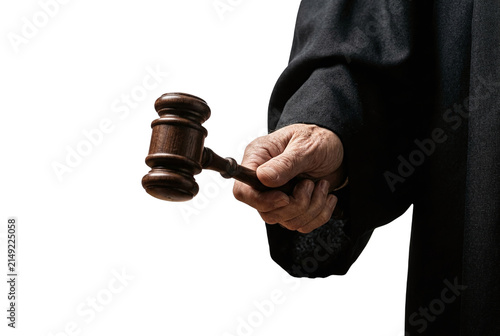 Judge hand holding wooden gavel in black robe