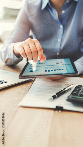 Analyzing business reports displayed on a digital tablet screen