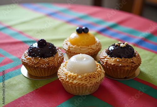 Four gourmet cupcakes with ...