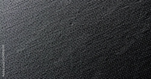 Black Woven Fabric Texture. Macro view of dark textile with fine diagonal weave and subtle shifting light.