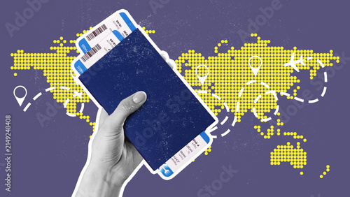 Canvas Print Planning a trip with travel tickets and a passport in hand while looking at a wo
