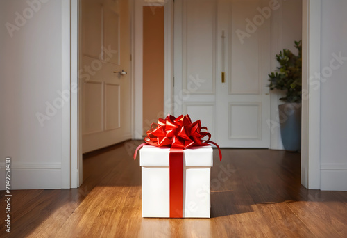 White gift box with a red b...