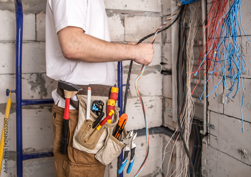 Canvas Print Professional Electrician Installing and Organizing Electrical Wiring in Resident