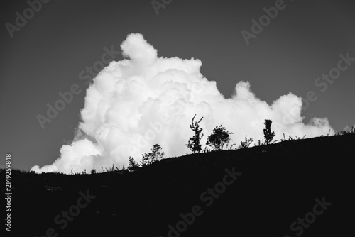 Принти на полотні expanding cloud formation over outdoor landscape with trees and hill at ground l