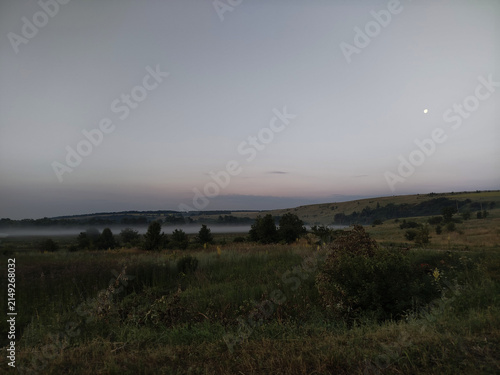Misty morning landscape over countryside fields