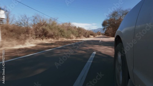 SUV wheel level side POV view driving on scenic road in Salta Argentina