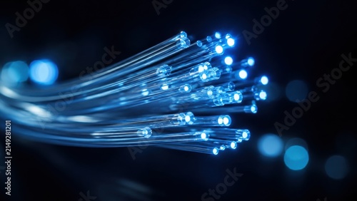 Glowing fiber optic strands in dark abstract background