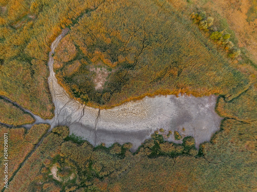 Aerial drone view of Lake Velence, Hungary, revealing severe drought, shrinking shoreline and dried wetlands during the summer.