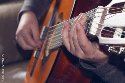 Canvas Print Close-up of hand playing chords on an acoustic guitar