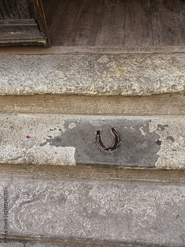 RIGA, LATVIA – JULY 28, 2017: Horseshoe Embedded in a Stone Entrance Step at St. Peter’s Boutique Hotel as a Traditional Good Luck Charm