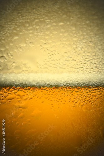 Macro shot of cold beer or juice glass with water drops and condensation