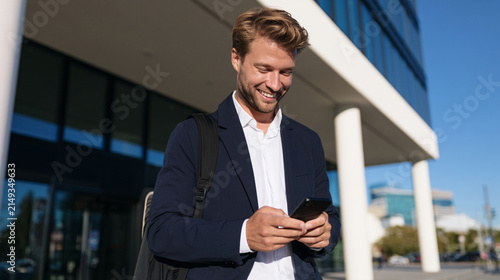 Connected Professional Using Smartphone While Walking Outside Modern Business Building