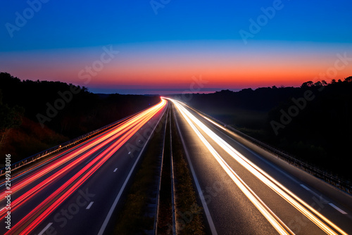 abstract  image of highway at night with busy light trail of cars on the road.at sunset
