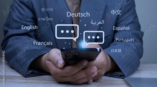 Obraz na plátne Businessman holding smartphone using language translation app for multilingual online chat and sending text message
