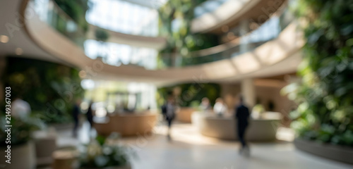 Fully blurred sustainable office lobby with abstract greenery, elegant reception forms and soft business silhouettes. Premium eco inspired commercial background for branding and marketing.