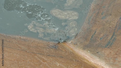 An industrial waste water is draining into public sewer. Representing urban water pollution, sewage system management. Environmental impact from industrial activity