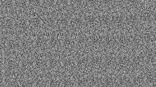 Full frame of black and white television static with occasional small bursts of colored pixel artifacts, looping as a retro screen noise background.