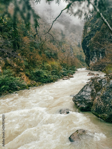 Canvas Print Misty mountain river rushing through a deep rocky canyon in Abkhazia, Caucasus