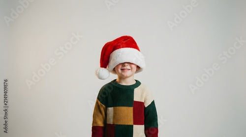 Cute child wearing a Santa hat eating sweet treats captured perfectly