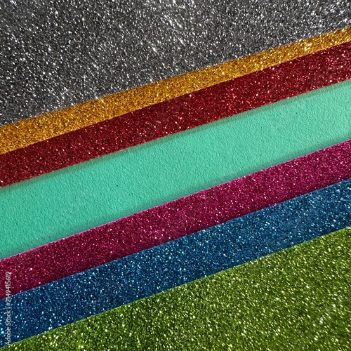 Diagonal stripes of multi-colored glitter paper textures