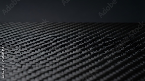 Close up of a black carbon fiber weave texture with detailed pattern with material