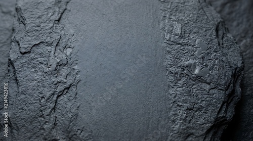 Close up of dark grey slate stone texture with rough with displays detailed view