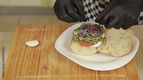 Chef prepares a fresh Mediterranean ciabatta sandwich