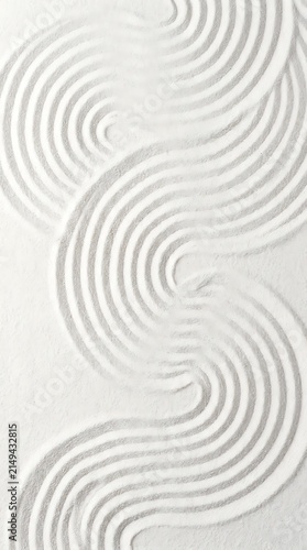 Intricate raked sand patterns with showcases detailed white patterns forming art