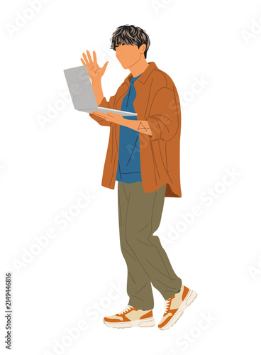 Young man walks while holding laptop. He waves, appearing friendly and engaged. Casual attire suits everyday or travel scenarios. Ideal for content on remote work or digital lifestyles