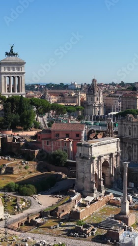 Aerial drone view over the historic center of Rome, Italy, featuring Capitoline Hill, the Altar of the Fatherland and the archaeological area of the Roman Forum. Panoramic view of Rome's historic arch