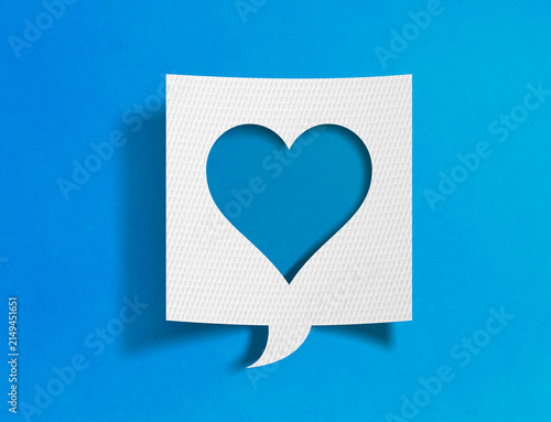 Heart speech bubble on blue background with paper cutout design