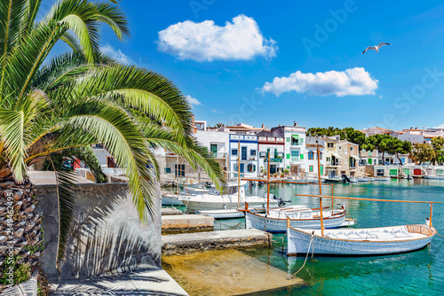 The harbor in the Old Town of Portocolom with traditional boats in front of the boathouses  – 20490